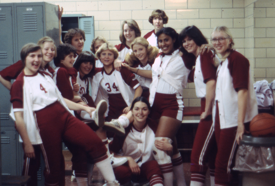 Archival photo of the Augsburg women’s basketball team posing for a photo in the locker room, 1978.